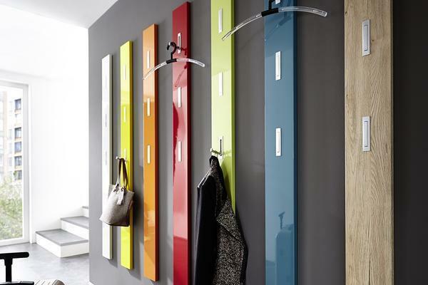 Multicolored hangers perfectly fit in the interior of the hallway, which is made in the style of high-tech