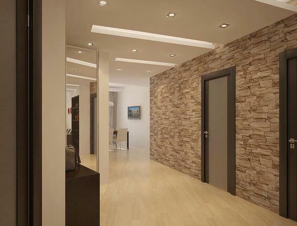The wall, decorated with decorative stone, looks great in the interior, which is made in the style of high-tech