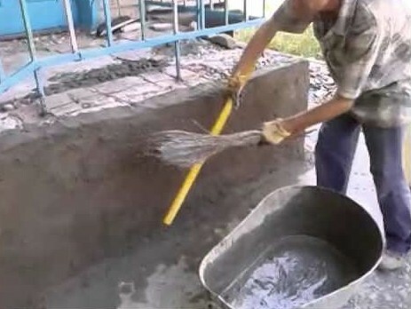 Plastering using a broom