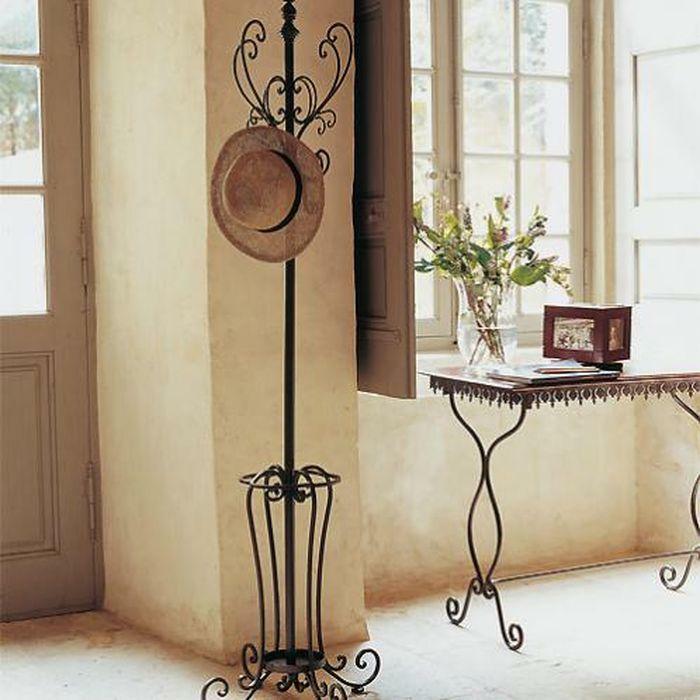Wrought iron hangers in the hall: metal photo, wall and floor, for the dress of the banquet, the parameters of the angular