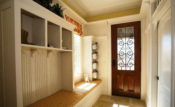 The perfect solution for a small hallway will be built-in furniture