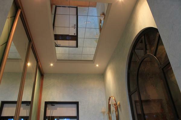 Several mirror surfaces in the hall visually increase the room